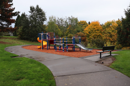 Hard surface trail – playground with bark chips – bench